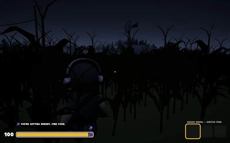 A player in a dark cornfield at night with a windmill in the distance
