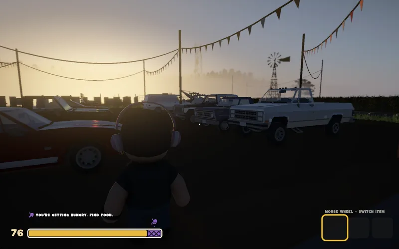 A player standing among parked pickup trucks at sunset